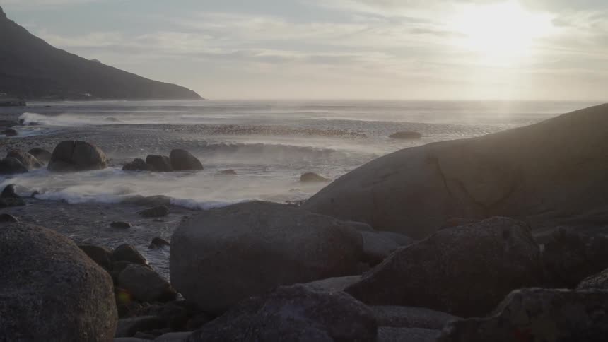The water is rough near the rocky shore