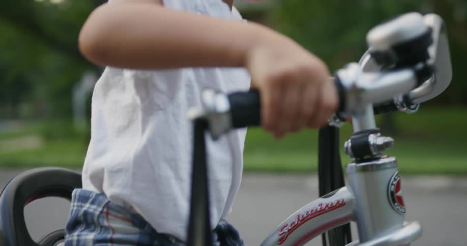 A child sits down on a trike