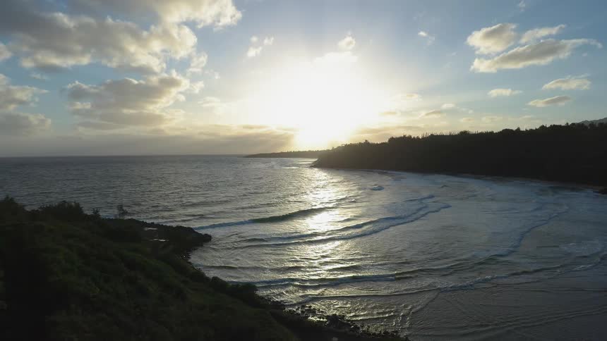 Waves come to shore at sunset