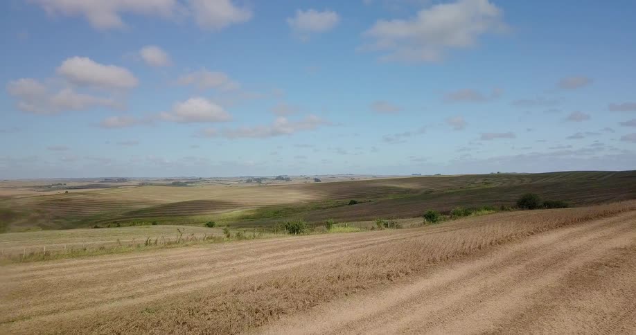 Tractors roll over dusty dirt landscape