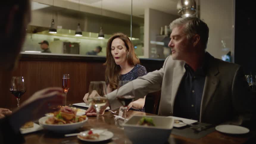 Two couples dine together at a restaurant