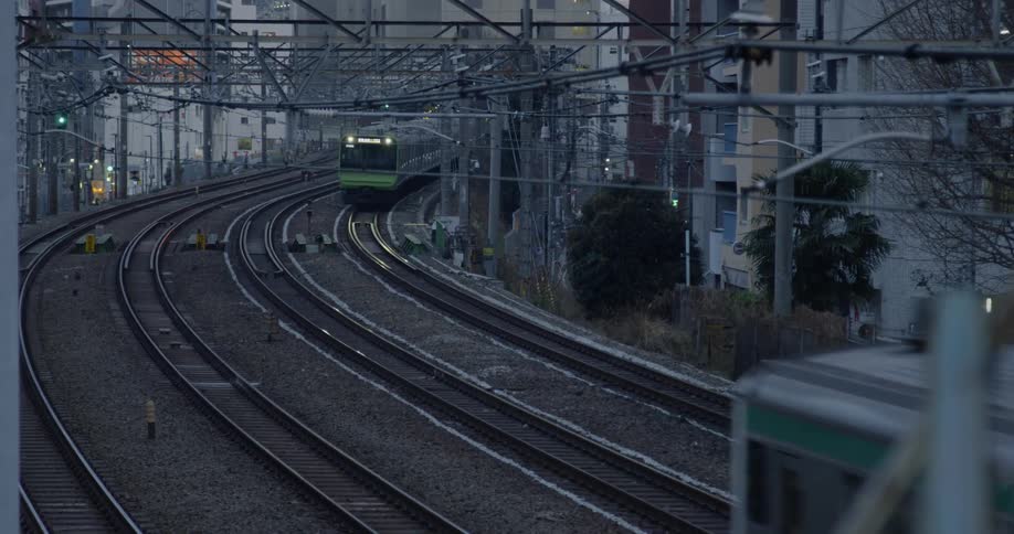 Trains roll down tracks through Tokyo