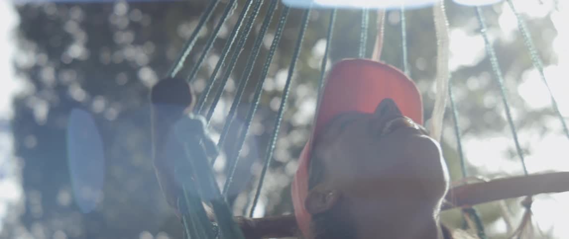 Person spins around slowly in a hammock on a sunny day