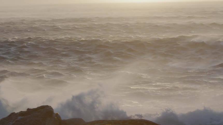 Waves crash and splash on the rocks