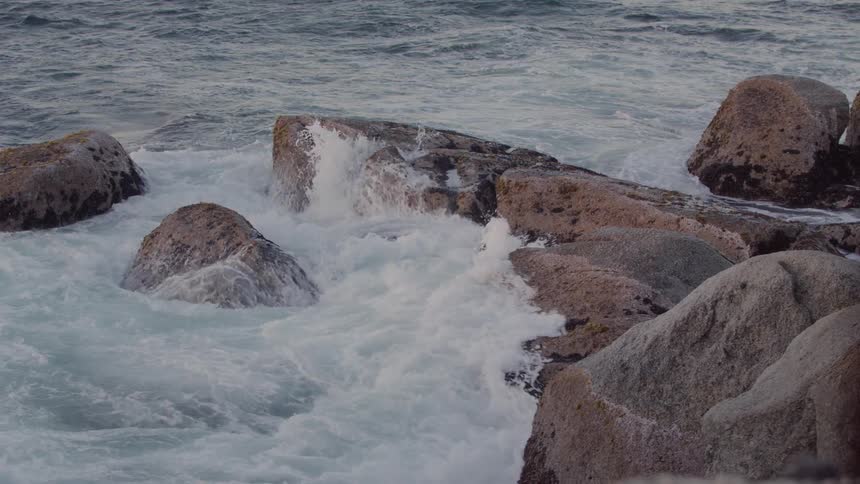 Water splashes up on rocks