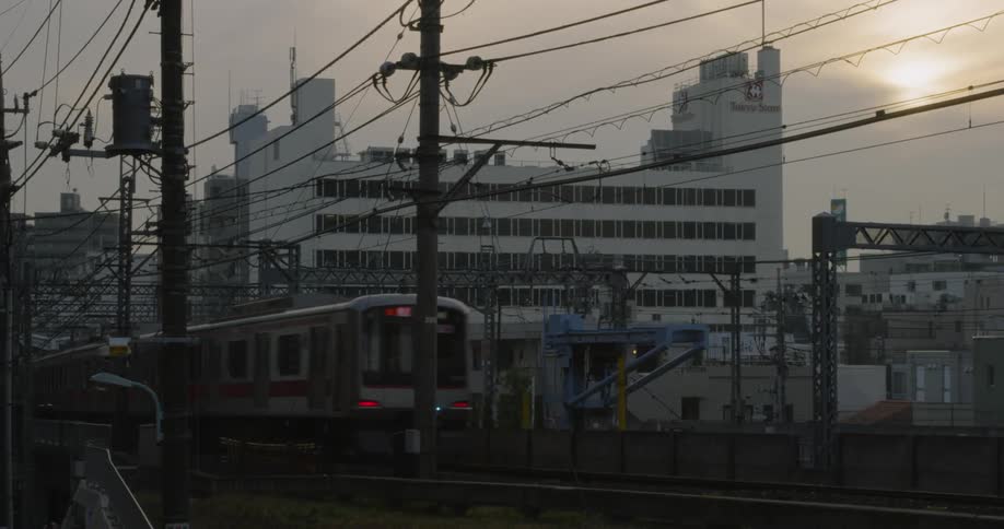 Train passes through Tokyo at sunset