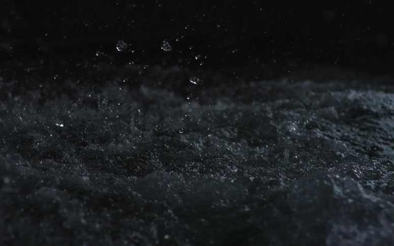 Water splashes down into a puddle