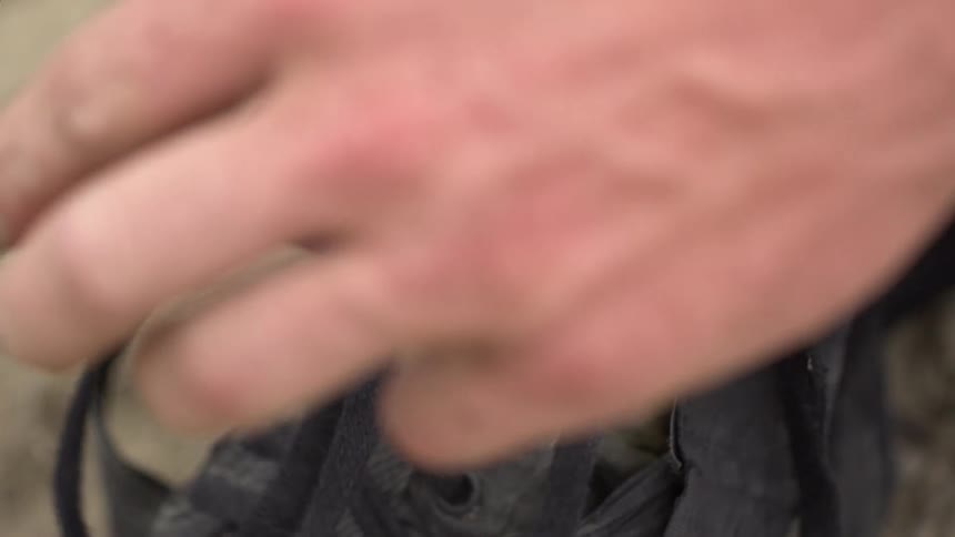 A close up shot of someone tying their shoes