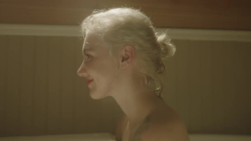 Woman with gray hair smiles as she stares