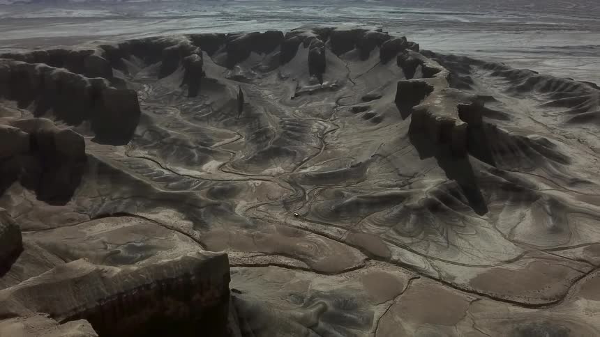 Sandy hilly landscape with paths running through