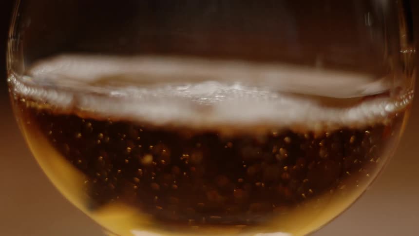 A sparkling drink is poured into a glass