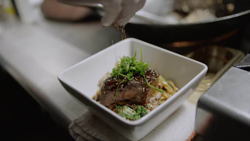 Chef prepares food while wearing white gloves
