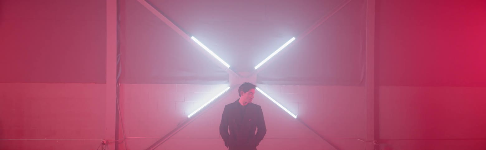 A man stands next to a light display