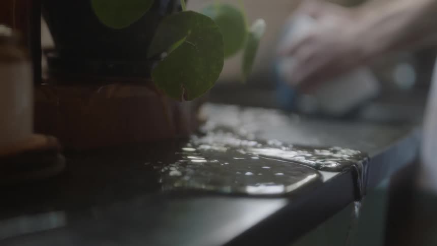 Water pours off the edge of a kitchen counter