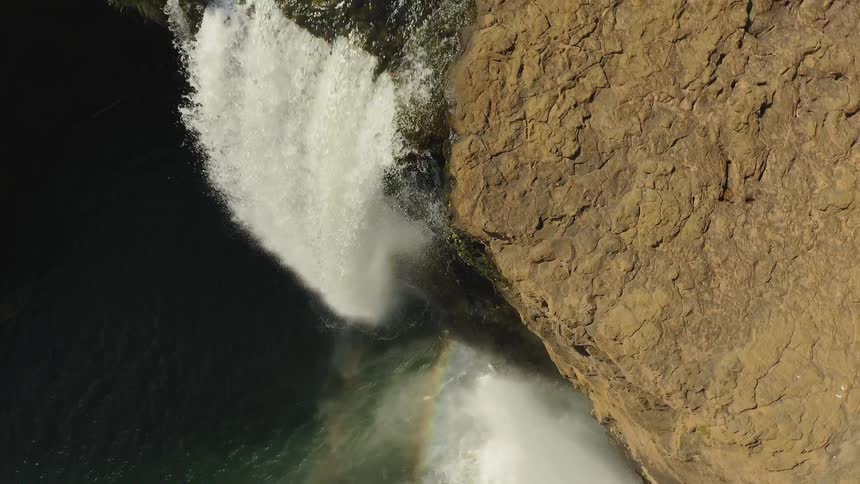 Water splashes down into a river below