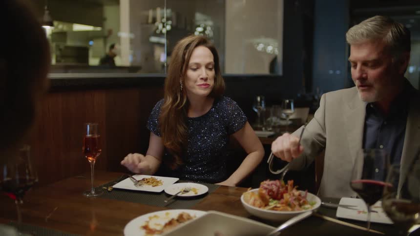 Group of people eat a meal in a restaurant