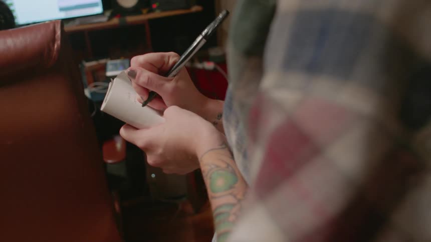 Person writes in a notebook