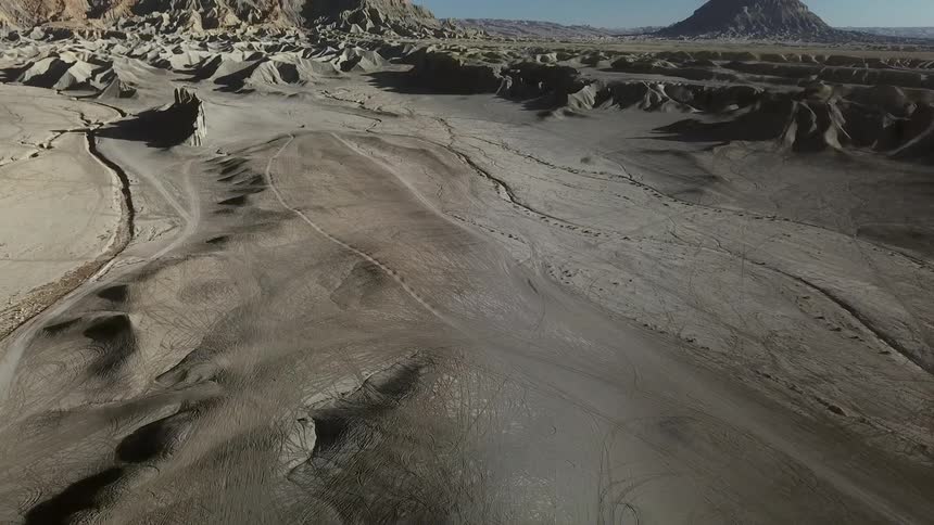 Sandy hilly landscape with paths running through