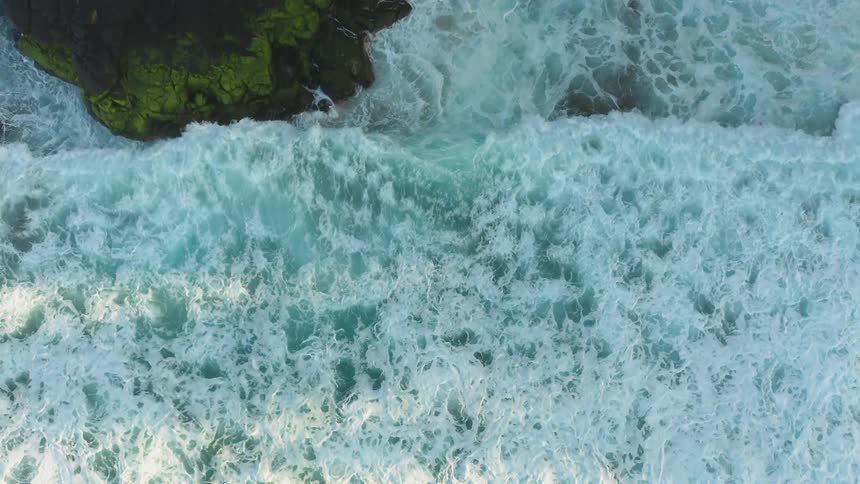 Ocean waves crash into a shoreline