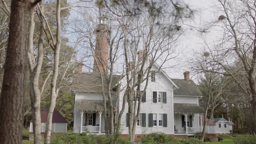 Large white house surrounded by trees