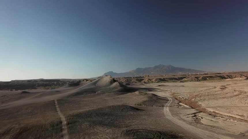 Sun sets over a vast hilly desert