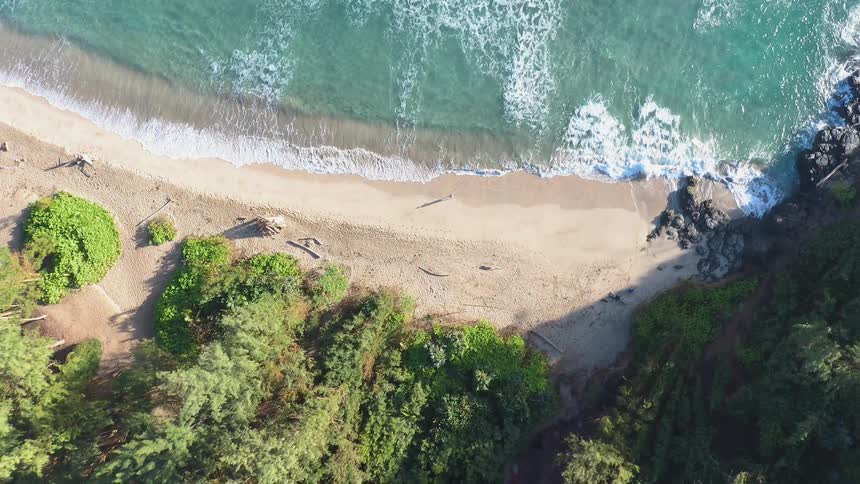 The tide flows onto the beach shore