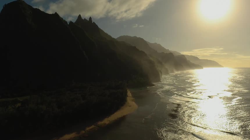 The sun sets over a coastline
