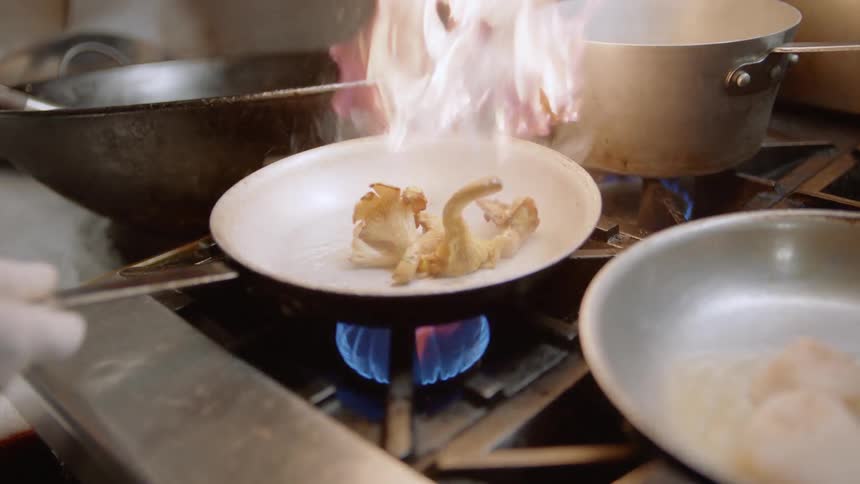 A chef cooks in a kitchen