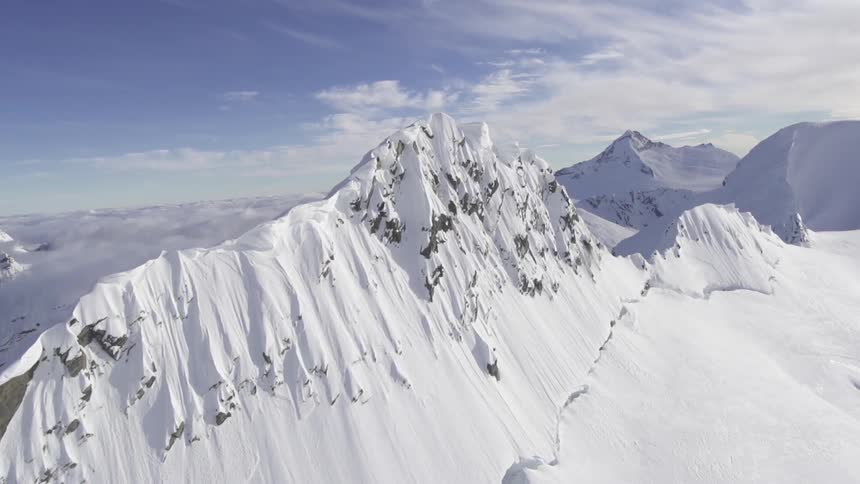 A steep mountain peak is covered in snow