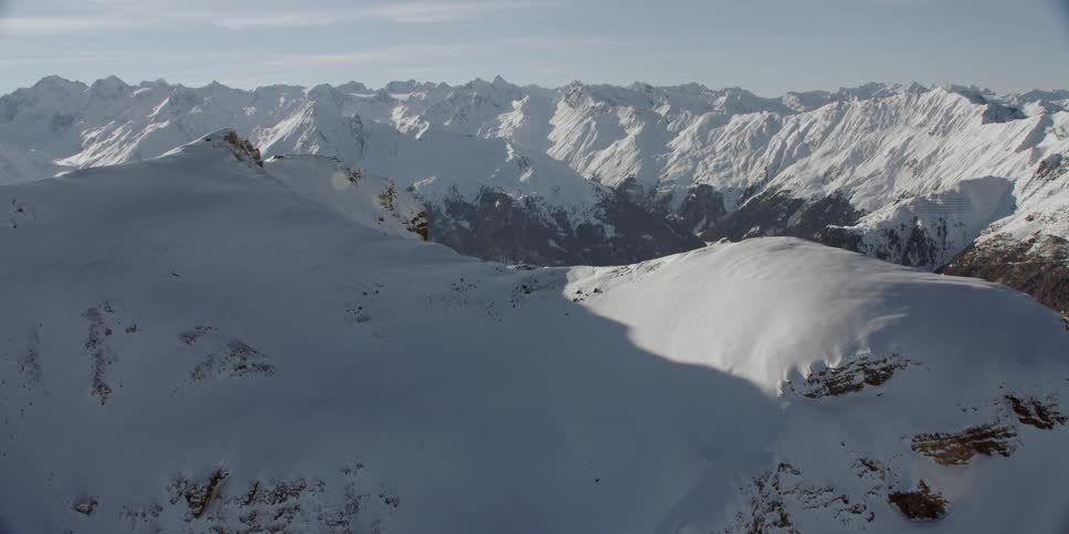 Snow covers the vast mountainous landscape