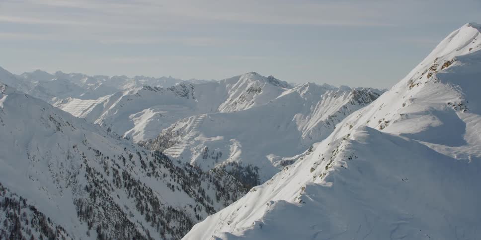 Snow covers the mountainous landscape