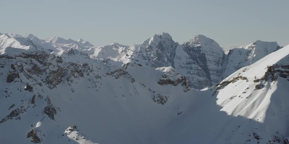 Snow covers mountains on a sunny day