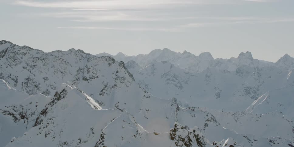 Snow covered mountains under a cloudy sky