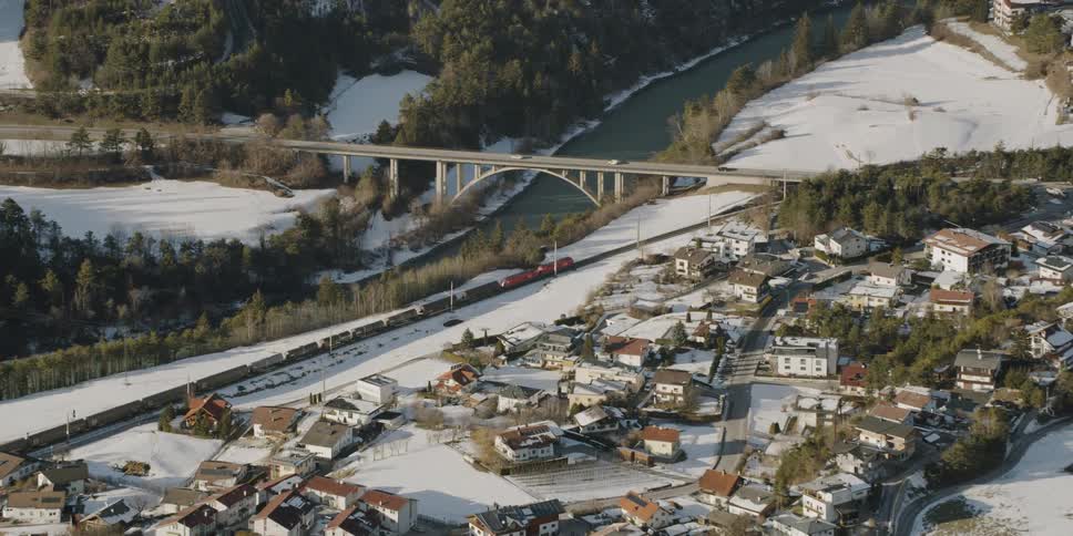 A train travels past a snow covered town