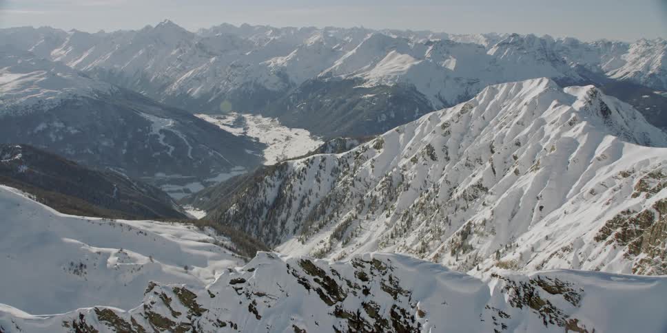 Snow covers the mountainous landscape