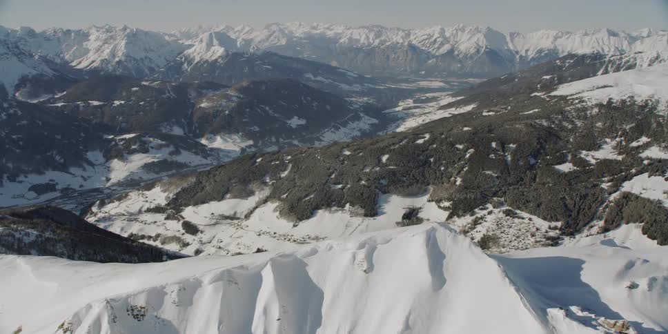 Sun shines down over snowy mountains