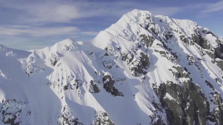 Very top of some snow covered mountains