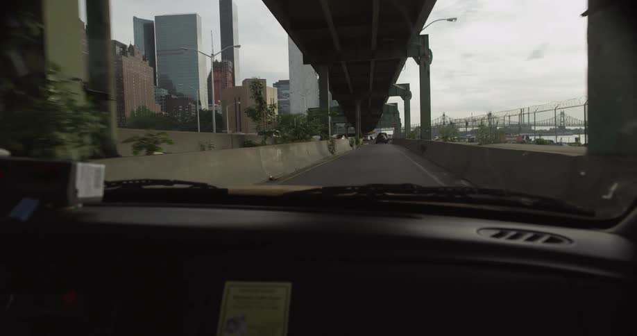 Car driving with large buildings up ahead