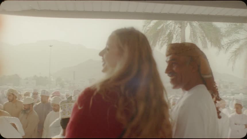 Woman talks to a man in a crowded village