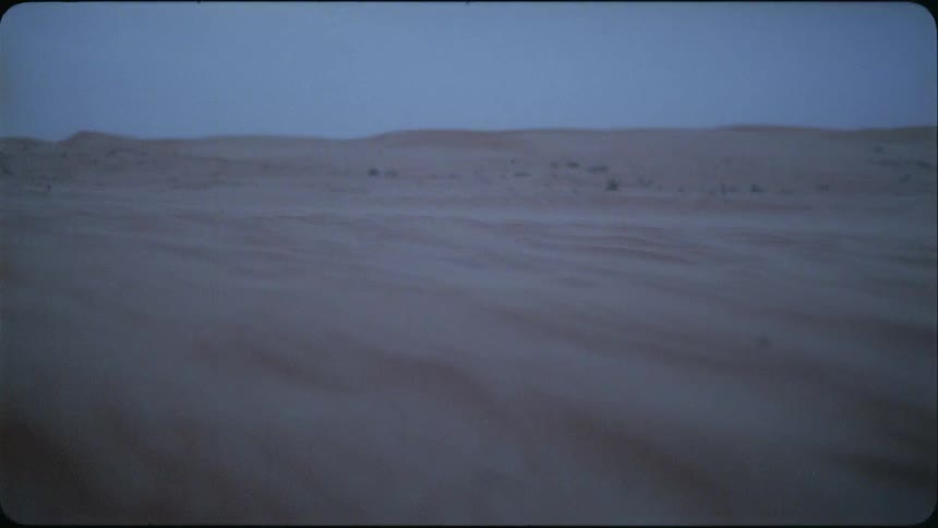 Sand blows across a desert