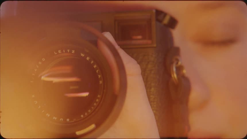 Person adjusts camera lens