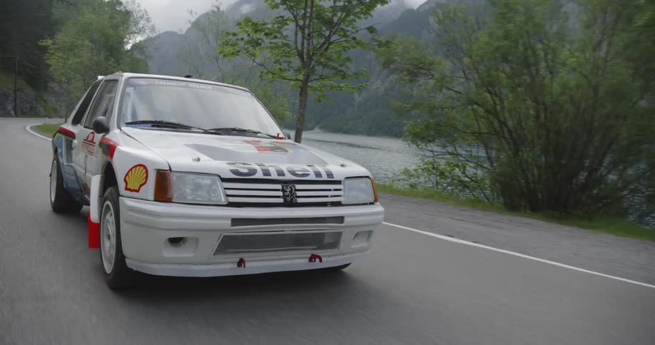 A touring car speeds around the mountain