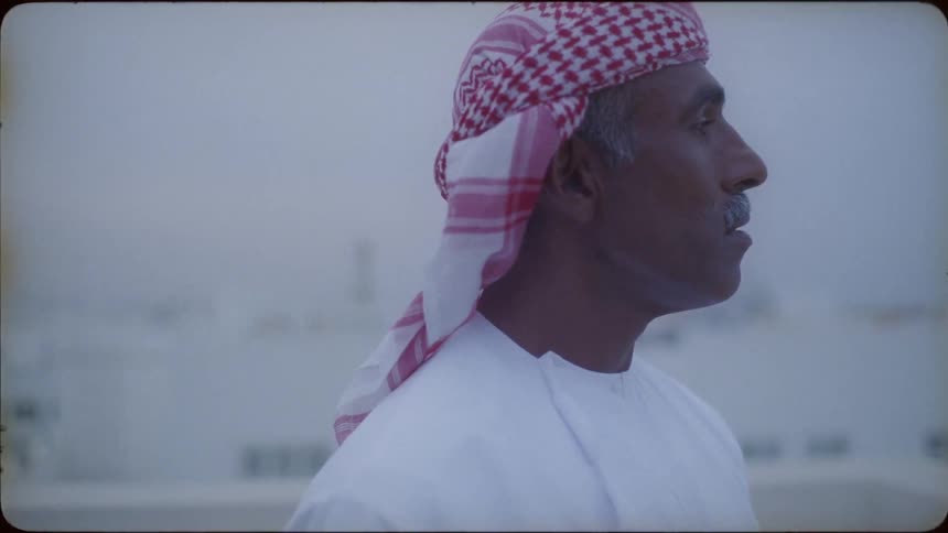 Man in turban stands on roof