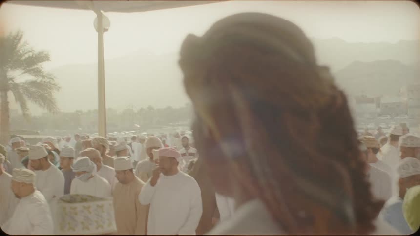 Crowd of villagers outside on a sunny day
