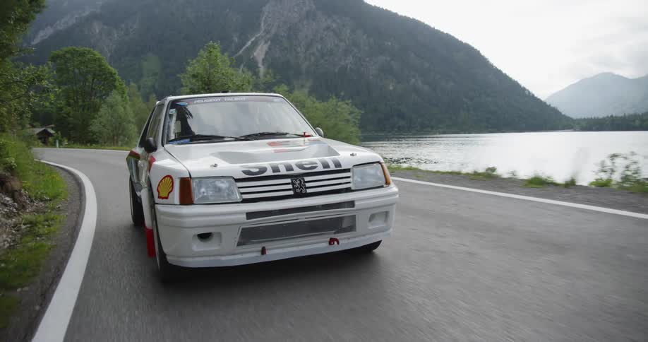 A touring car is driven by the lake
