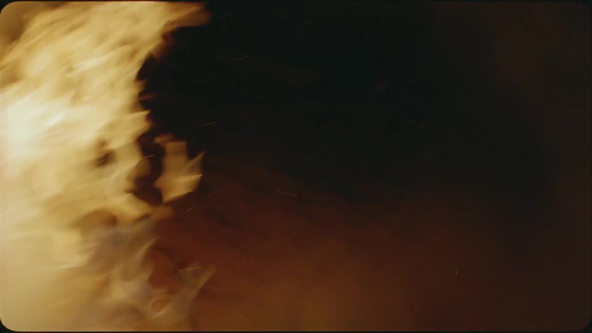 A fire burns in the dark
