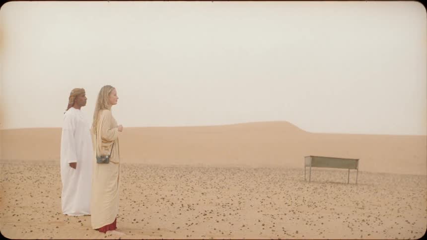 Man and woman stand in the desert