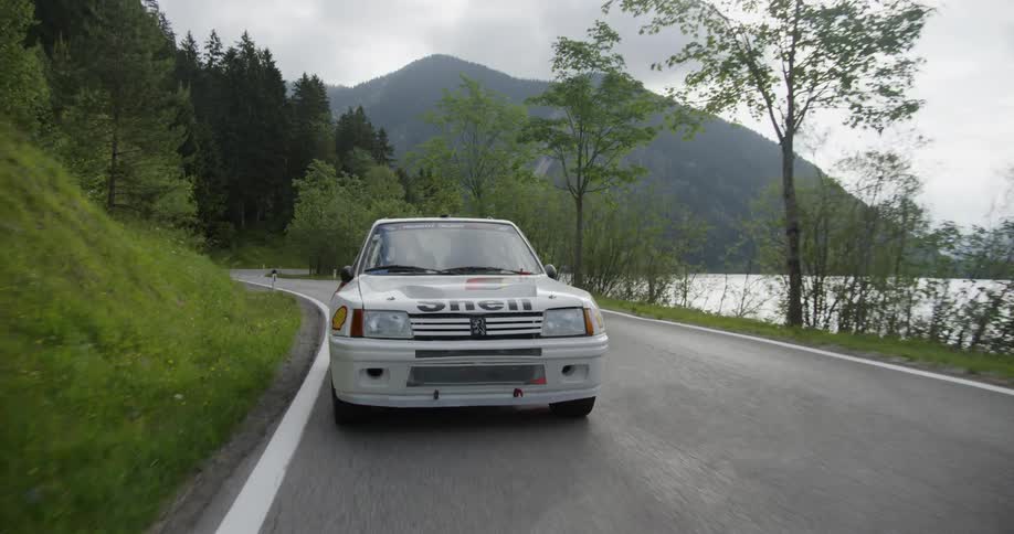 A touring car speeds on the road