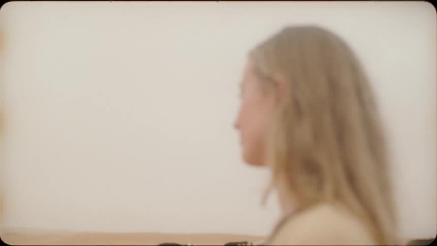 Woman looks out at the animals moving through the desert