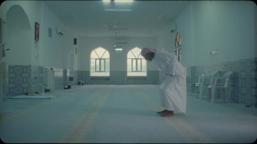 Man kneels to pray inside a building
